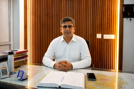 Mr. Mahendra Singh sitting at desk